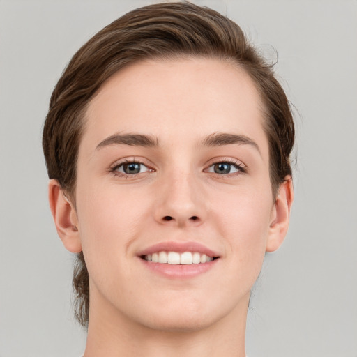 Joyful white young-adult female with short  brown hair and grey eyes