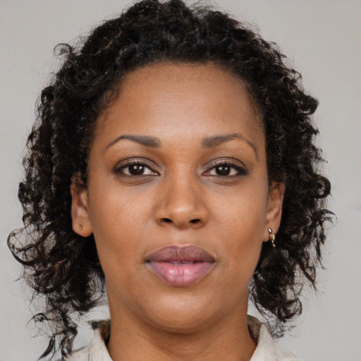 Neutral black young-adult female with medium  brown hair and brown eyes