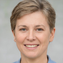 Joyful white adult female with short  brown hair and grey eyes