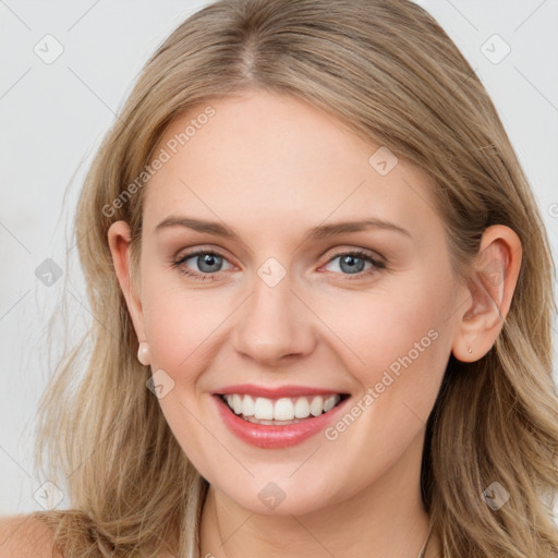 Joyful white young-adult female with long  brown hair and blue eyes