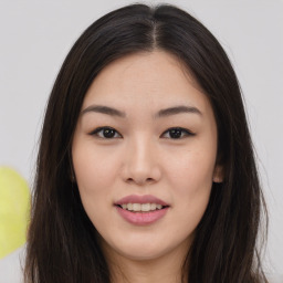 Joyful asian young-adult female with long  brown hair and brown eyes