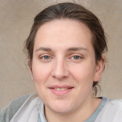 Joyful white adult female with medium  brown hair and grey eyes