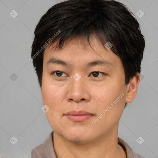 Joyful asian young-adult male with short  brown hair and brown eyes