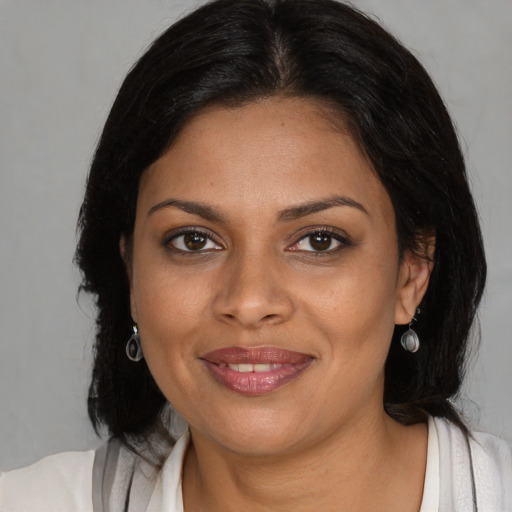 Joyful black young-adult female with medium  brown hair and brown eyes