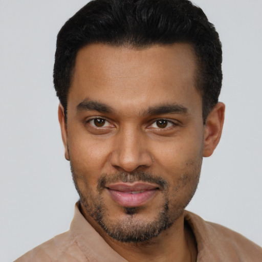 Joyful black young-adult male with short  black hair and brown eyes