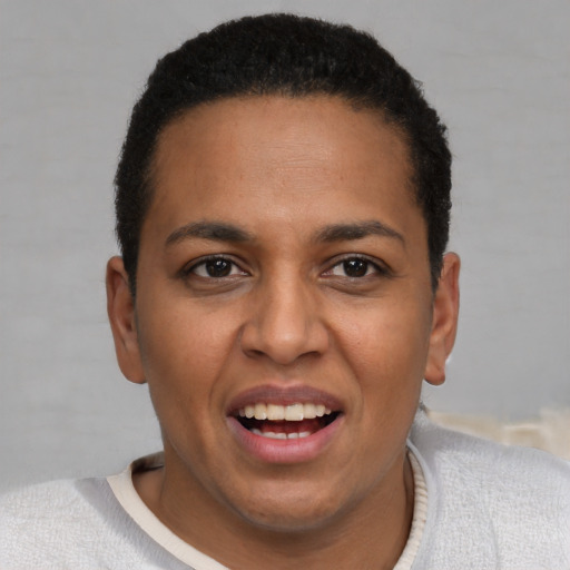 Joyful black young-adult female with short  black hair and brown eyes