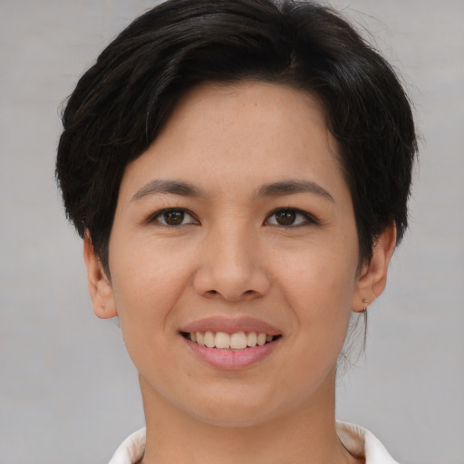 Joyful white young-adult female with short  brown hair and brown eyes