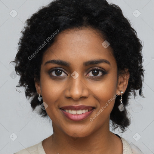 Joyful black young-adult female with long  black hair and brown eyes