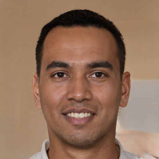 Joyful white young-adult male with short  black hair and brown eyes