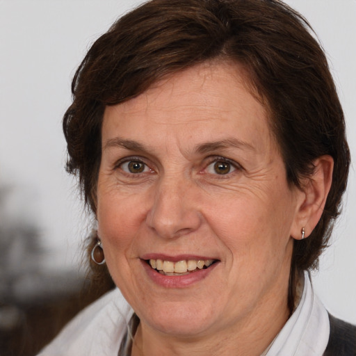 Joyful white adult female with medium  brown hair and brown eyes