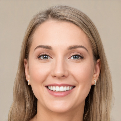 Joyful white young-adult female with long  brown hair and green eyes