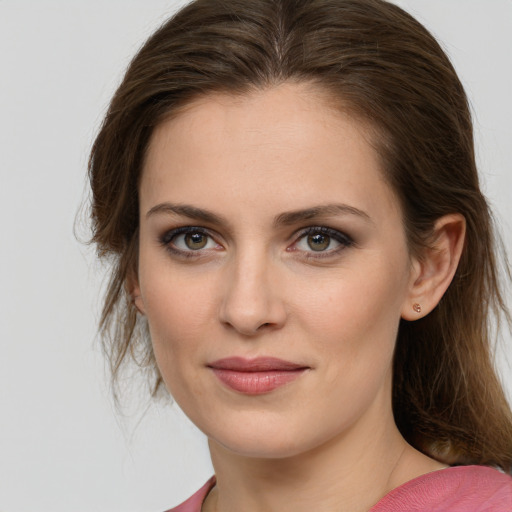 Joyful white young-adult female with long  brown hair and blue eyes