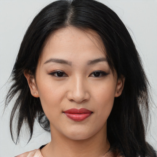 Joyful asian young-adult female with medium  black hair and brown eyes