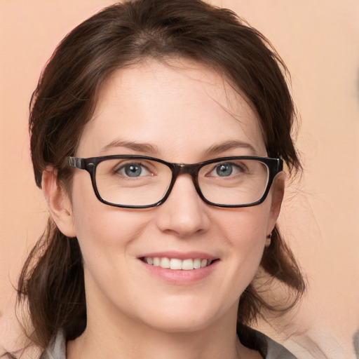 Joyful white young-adult female with medium  brown hair and blue eyes