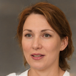 Joyful white adult female with medium  brown hair and brown eyes