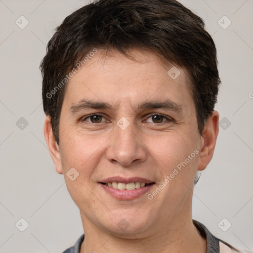 Joyful white adult male with short  brown hair and brown eyes