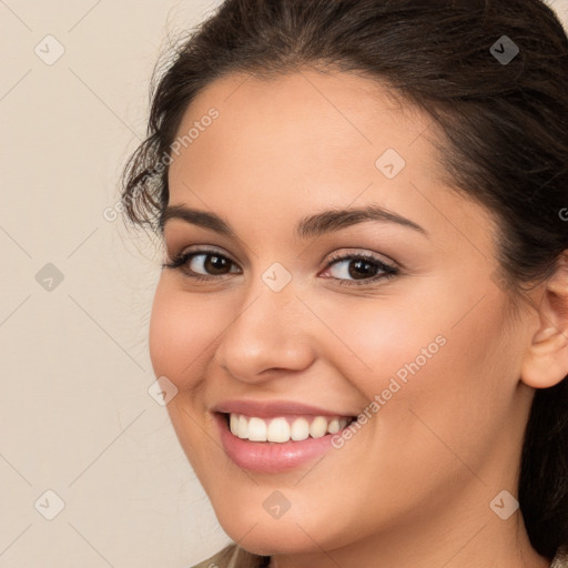 Joyful white young-adult female with long  brown hair and brown eyes