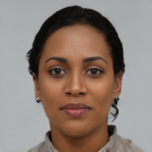 Joyful latino young-adult female with short  black hair and brown eyes