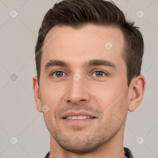 Joyful white young-adult male with short  brown hair and brown eyes