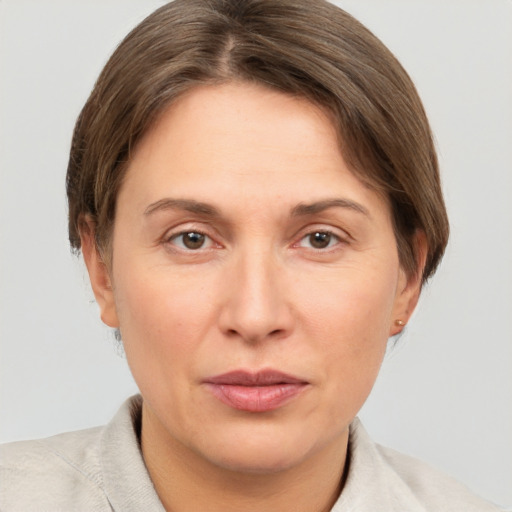 Joyful white adult female with short  brown hair and grey eyes