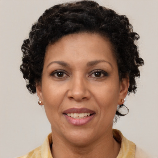 Joyful latino adult female with short  brown hair and brown eyes