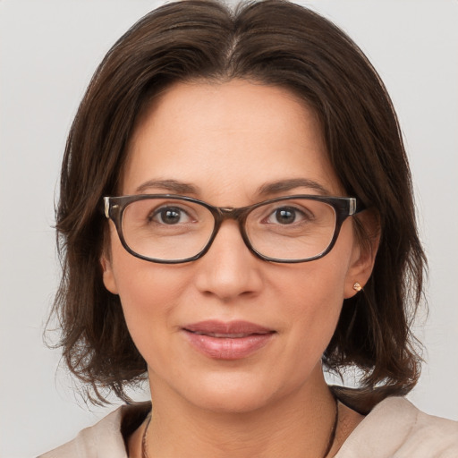 Joyful white adult female with medium  brown hair and brown eyes