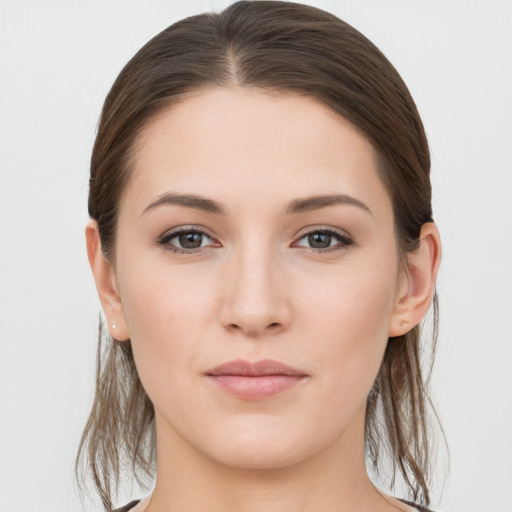 Joyful white young-adult female with long  brown hair and grey eyes