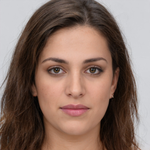 Joyful white young-adult female with long  brown hair and brown eyes