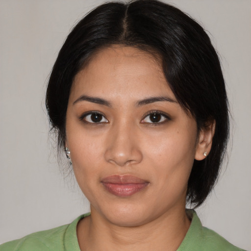Joyful latino young-adult female with medium  black hair and brown eyes