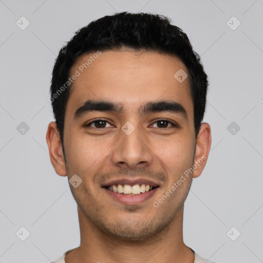 Joyful latino young-adult male with short  black hair and brown eyes