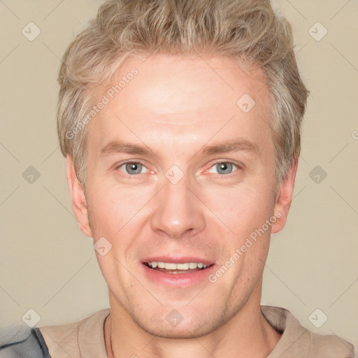 Joyful white adult male with short  brown hair and grey eyes