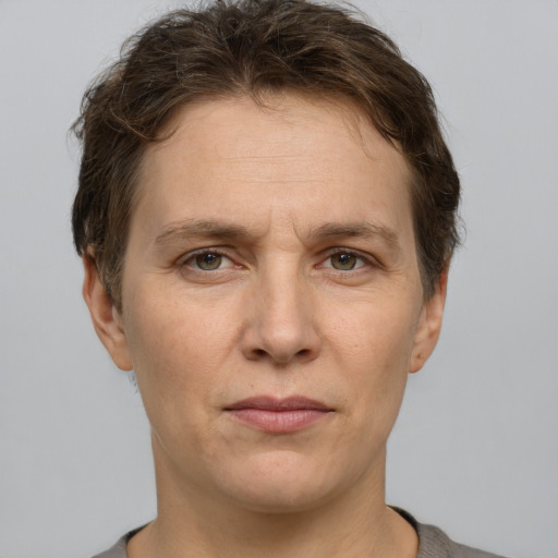 Joyful white adult female with short  brown hair and grey eyes