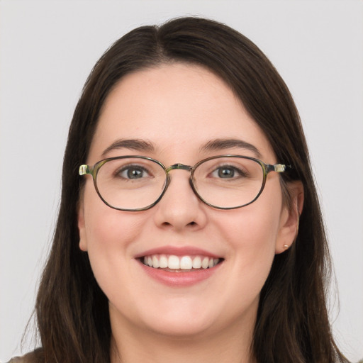 Joyful white young-adult female with long  brown hair and grey eyes