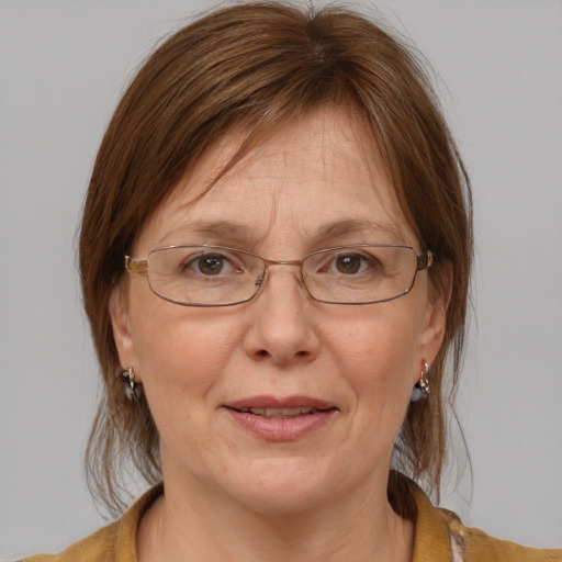 Joyful white middle-aged female with medium  brown hair and blue eyes