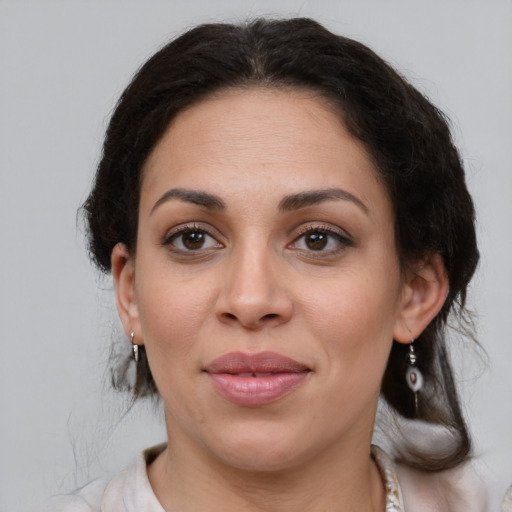 Joyful white adult female with medium  brown hair and brown eyes