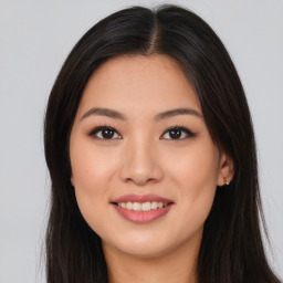 Joyful asian young-adult female with long  brown hair and brown eyes