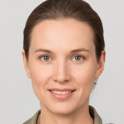 Joyful white young-adult female with medium  brown hair and grey eyes