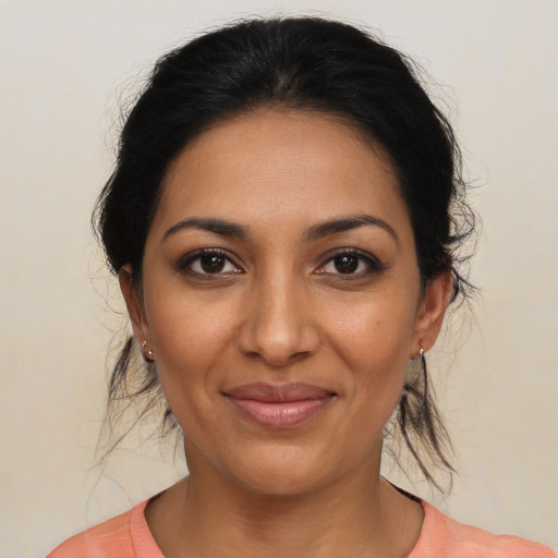 Joyful latino young-adult female with medium  brown hair and brown eyes