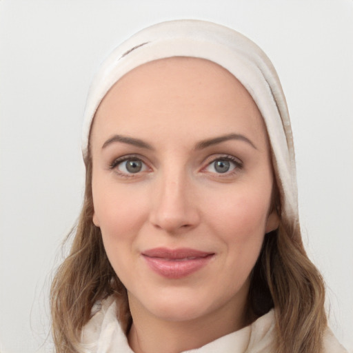 Joyful white young-adult female with medium  brown hair and blue eyes