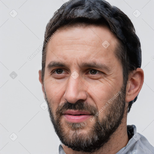 Joyful white adult male with short  black hair and brown eyes