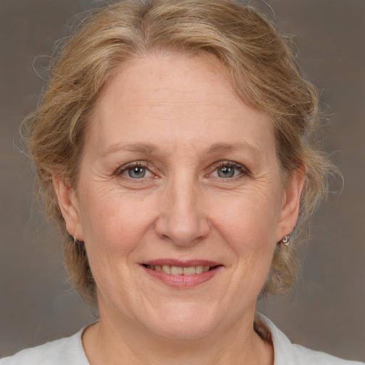 Joyful white middle-aged female with medium  brown hair and brown eyes