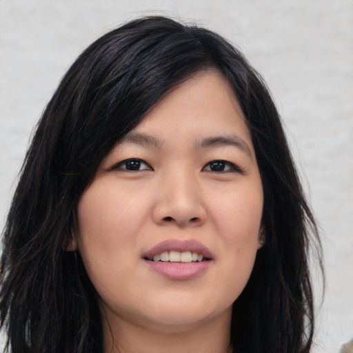 Joyful asian young-adult female with long  black hair and brown eyes