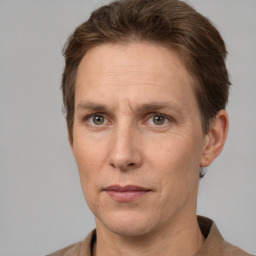 Joyful white adult male with short  brown hair and grey eyes