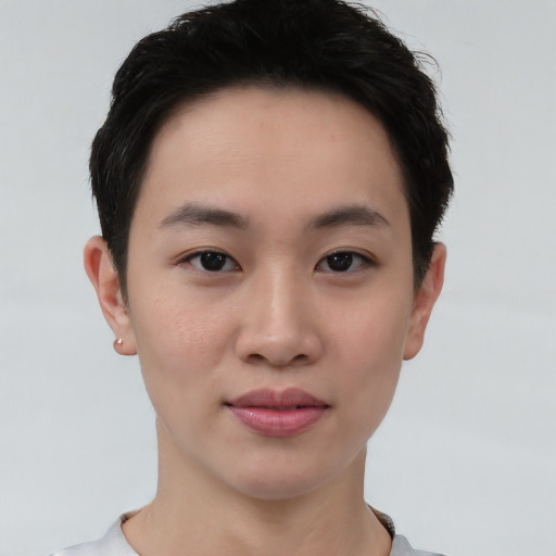 Joyful asian young-adult female with short  brown hair and brown eyes