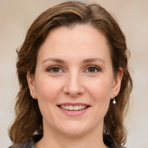 Joyful white young-adult female with medium  brown hair and green eyes