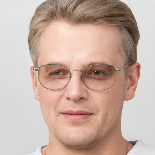 Joyful white adult male with short  brown hair and grey eyes