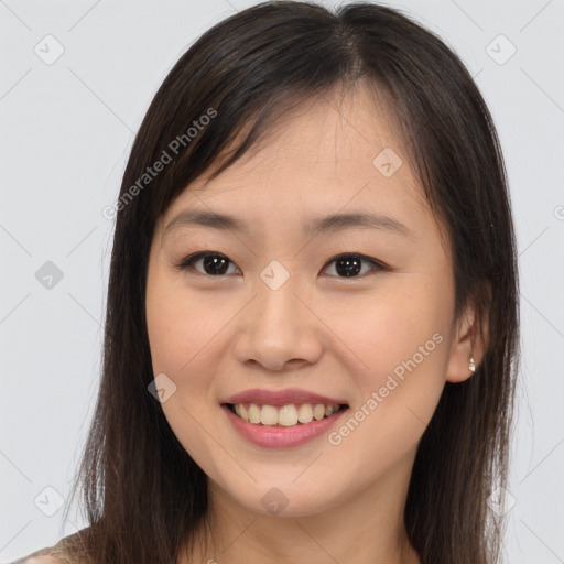 Joyful asian young-adult female with long  brown hair and brown eyes