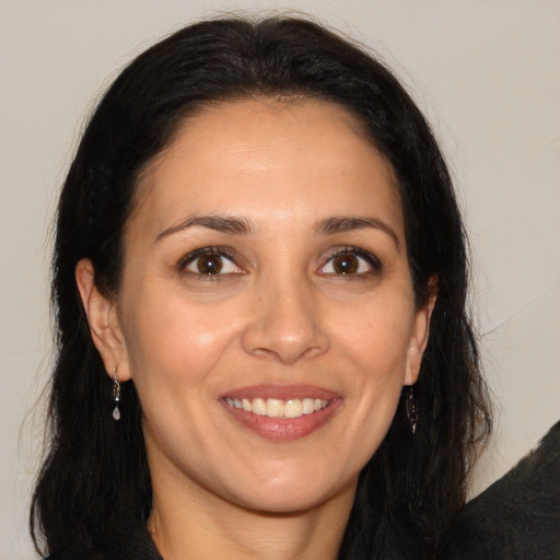 Joyful white adult female with long  brown hair and brown eyes