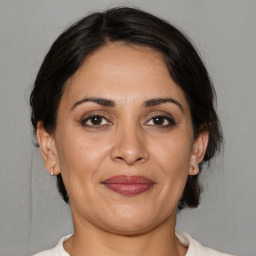 Joyful white adult female with medium  brown hair and brown eyes