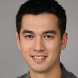 Joyful white young-adult male with short  black hair and brown eyes